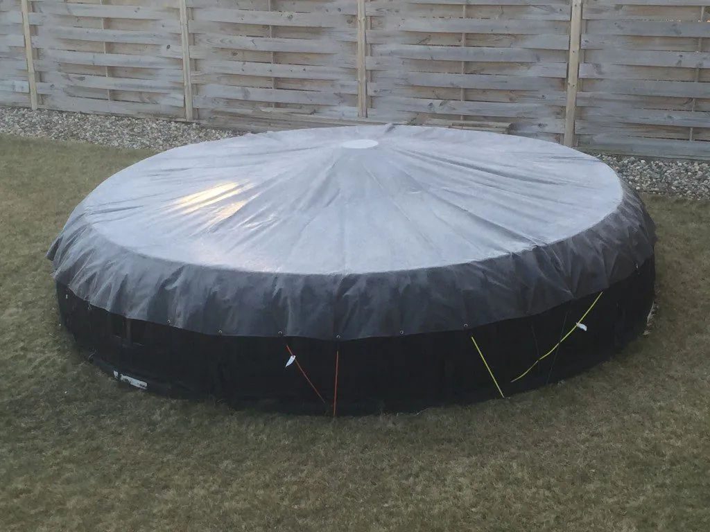 Round trampoline under a fitted winter trampoline cover