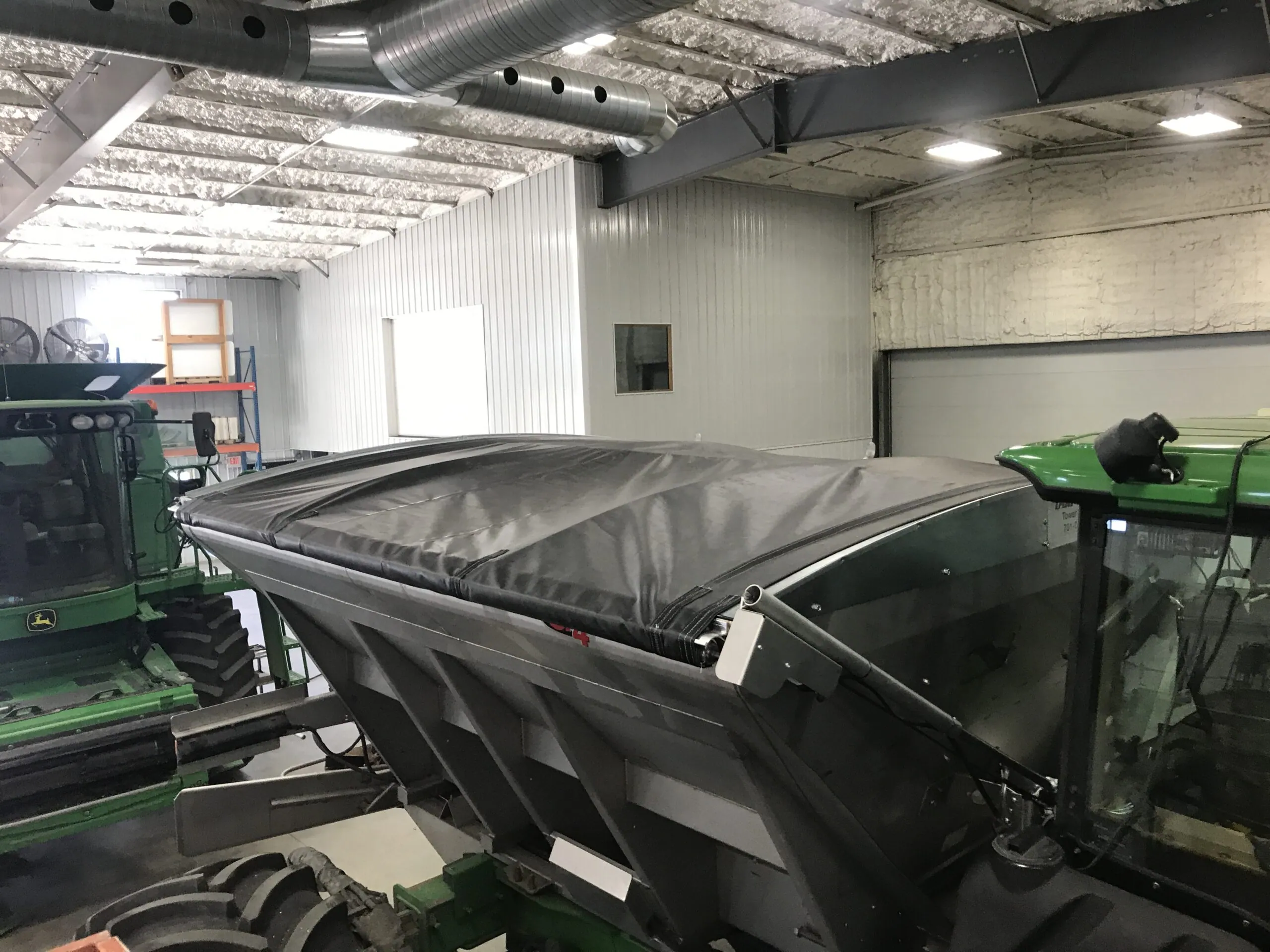 Seed tender with an electric roll tarp, inside the shop
