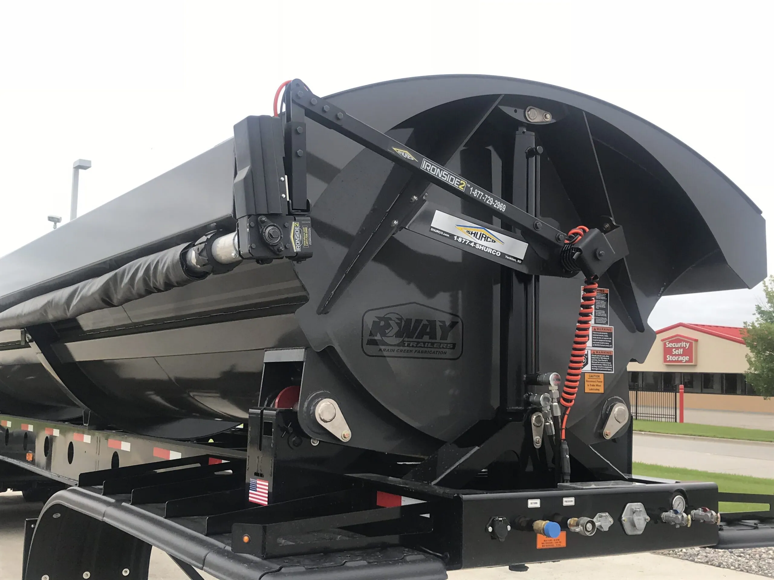 Dump trailer with a Shur-Lok roll tarp rolled open